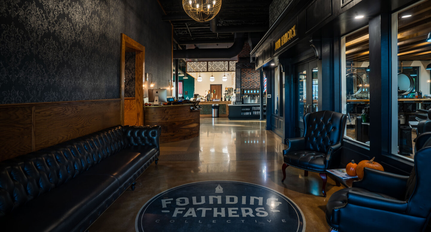 Founding Fathers Hero Lobby of Founding Fathers Collective featuring leather seating, barbershop entrance, and décor