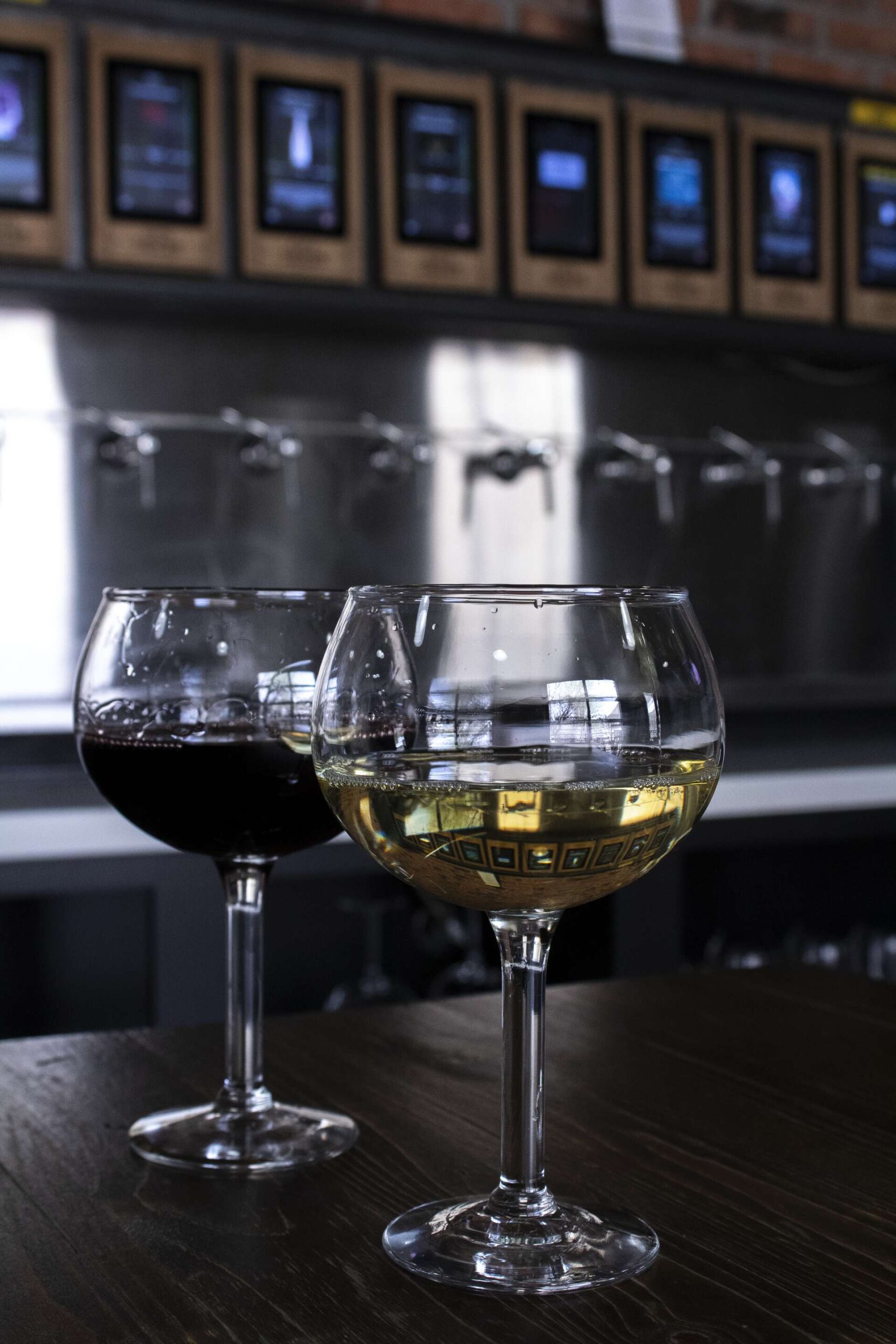 Glass of white and red wine on the bar counter at Founding Fathers Collective