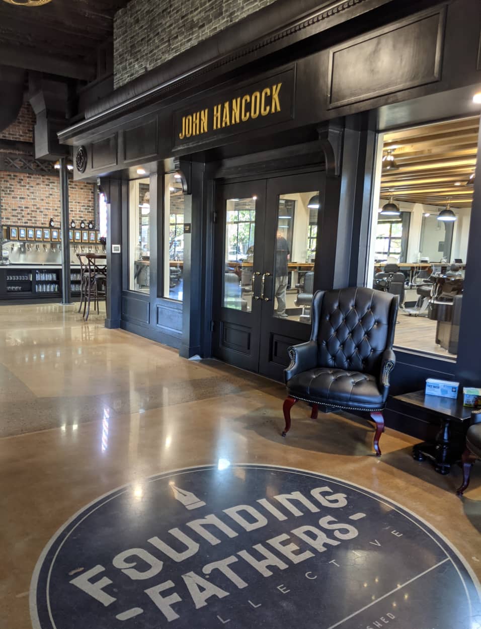 The Shop Entrance of John Hancock Barbershop inside Founding Fathers Collective with leather chair