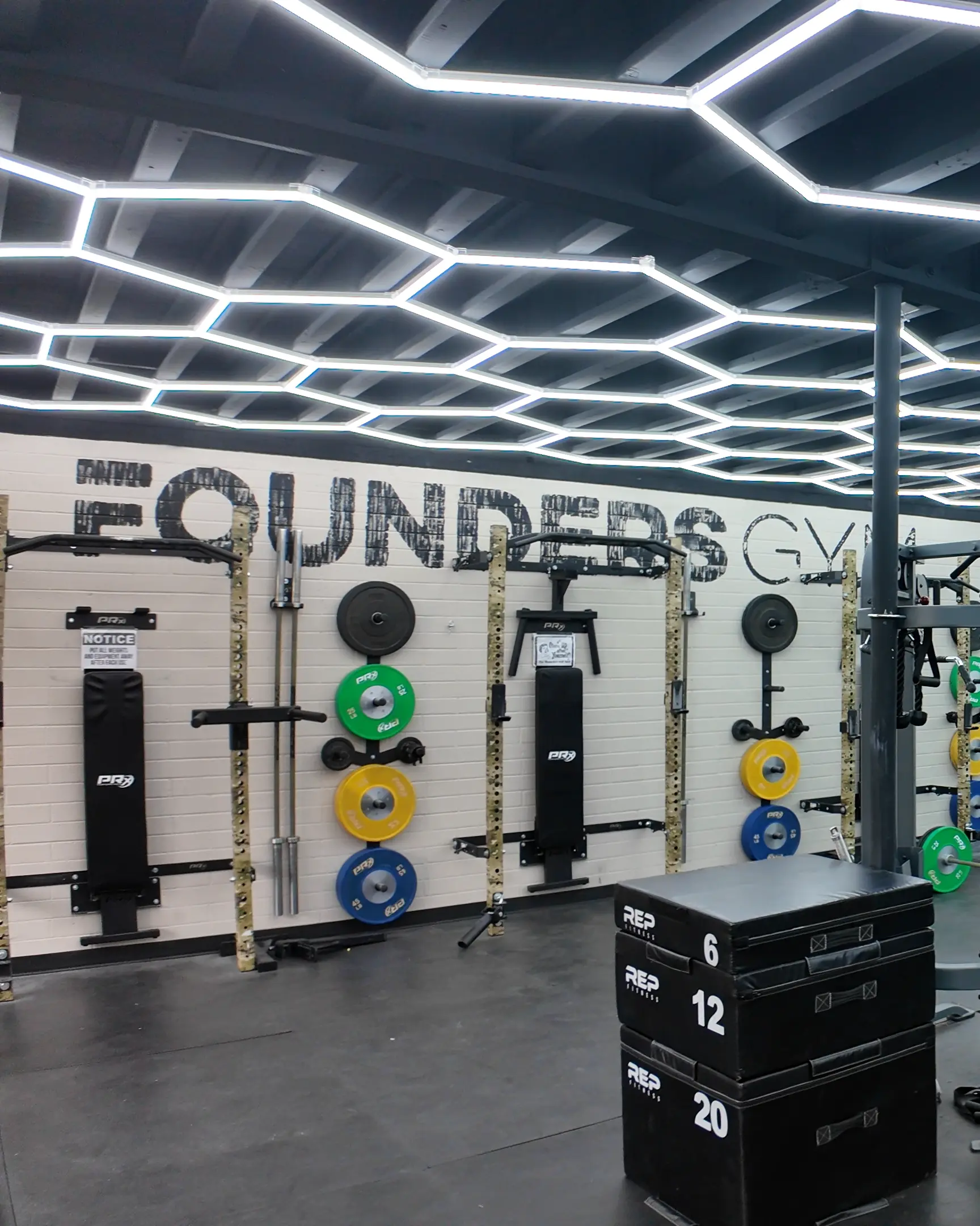 Founders Gym Prescott AZ Modern weightlifting area at Founders Gym with racks, plates, and LED ceiling lights